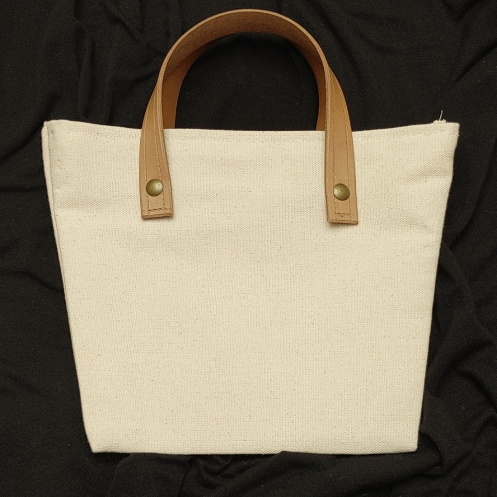 Handmade canvas tote with floral lining and veg tanned leather handles